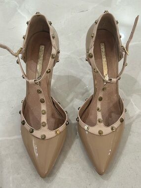 Audrey Brooke Nude Patent Pointed T-Strap Heels with Gold Studs